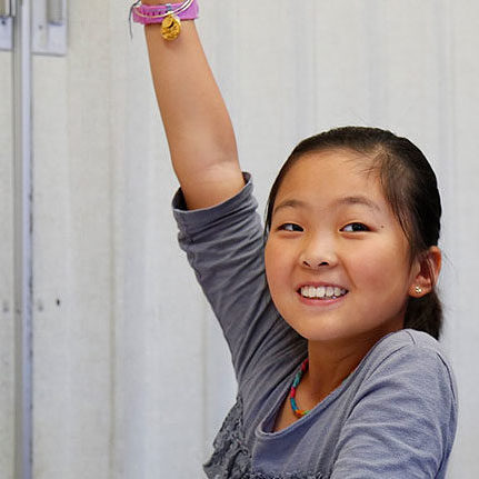 students raising their hands