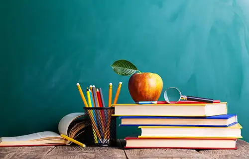 A stack of books with an apple